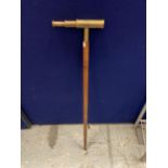 A WALKING STICK WITH A BRASS TELESCOPE HANDLE