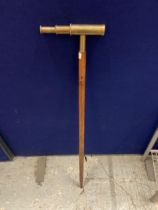 A WALKING STICK WITH A BRASS TELESCOPE HANDLE