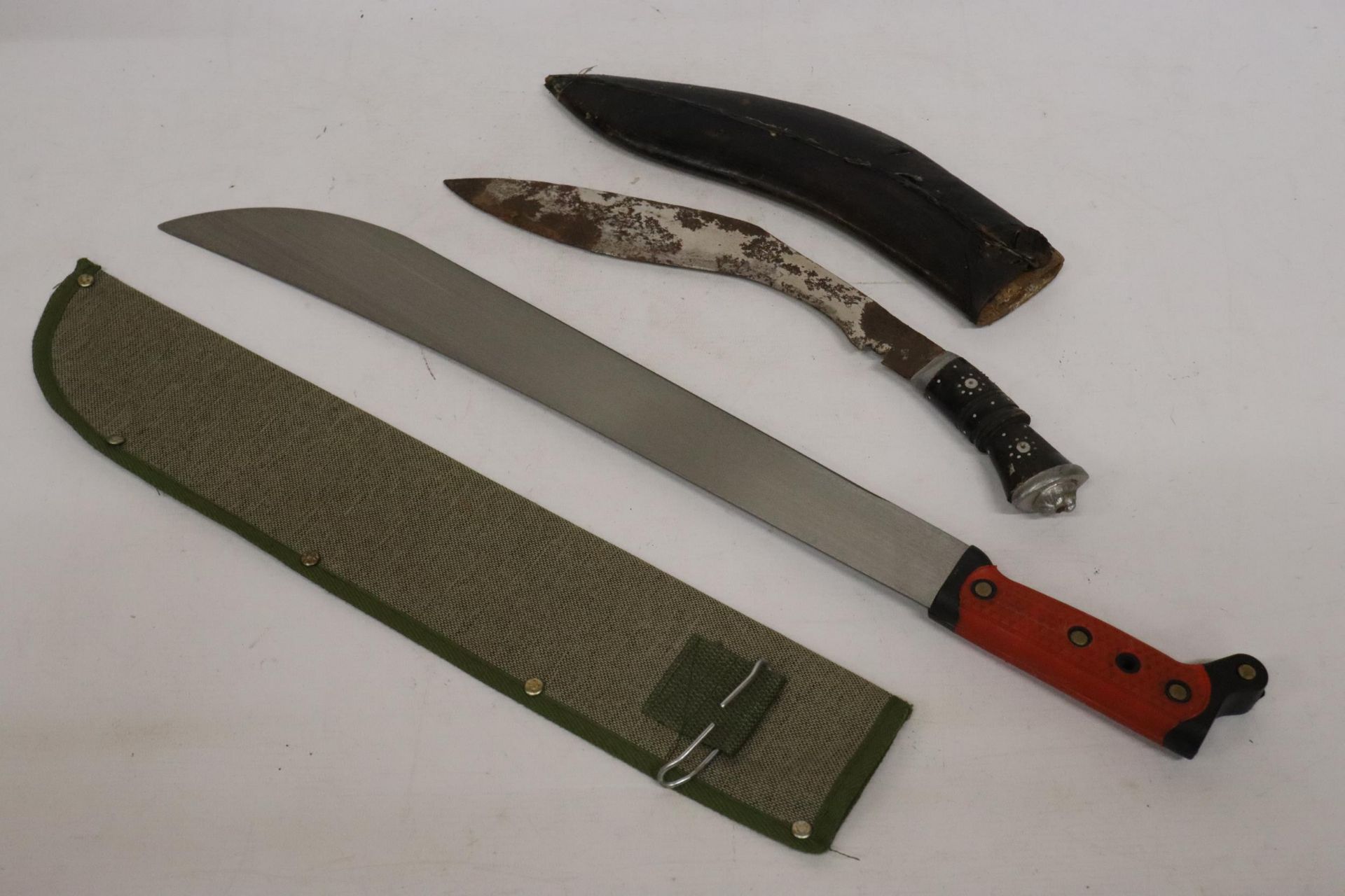 A VINTAGE GURKAH KUKRI KNIFE AND A MACHETE, BOTH IN SHEATHS