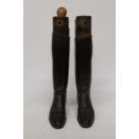 A PAIR OF VINTAGE LEATHER RIDING BOOTS WITH WOODEN BOOT TREES