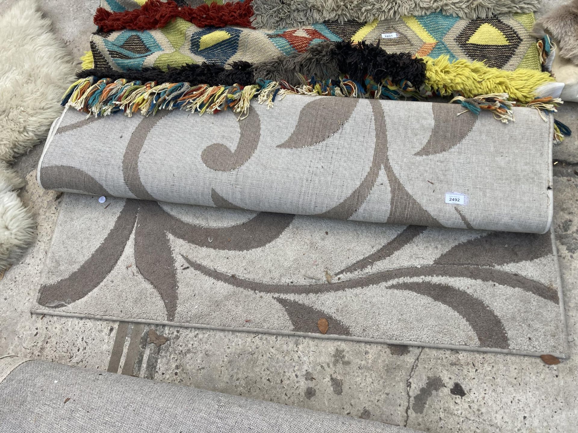 A SMALL CREAM PATTERNED RUG