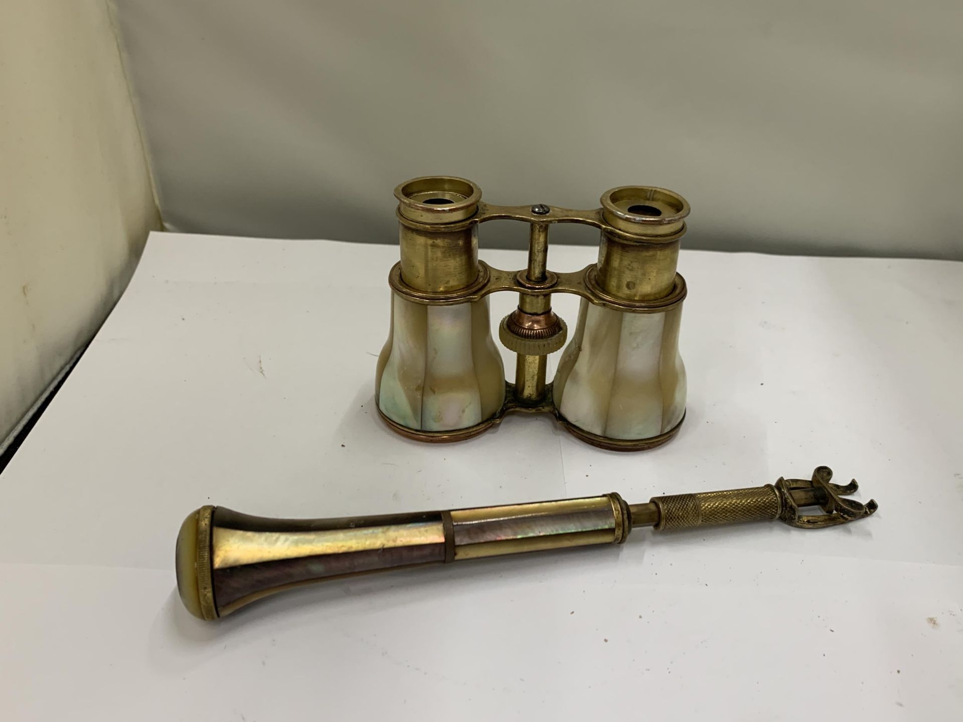 AN ANTIQUE PAIR OF MOTHER OF PEARL OPERA GLASSES WITH A MATCHING HANDLE