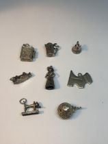 EIGHT VARIOUS SILVER CHARMS