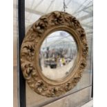 A GILT FRAMED CIRCULAR WALL MIRROR WITH CONVEX GLASS