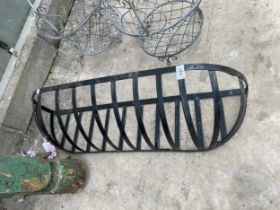 A SMALL METAL HAYRACK PLANTER