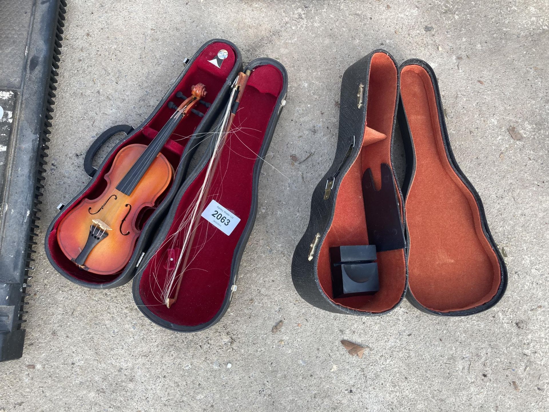 A MINITURE VIOLIN WITH CARRY CASE AND A CARRY CASE FOR A MINIATURE GUITAR