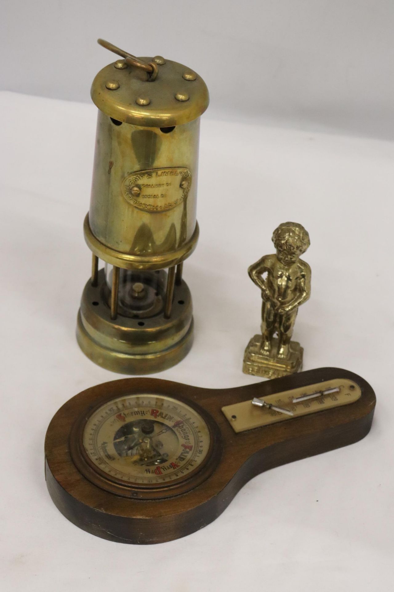 A BRASS MINER'S LAMP TOGETHER WITH A BAROMETER AND BRASS FIGURE