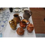 SIX STONEWARE ITEMS TO INCLUDE JUGS, EWER AND LIDDED POTS