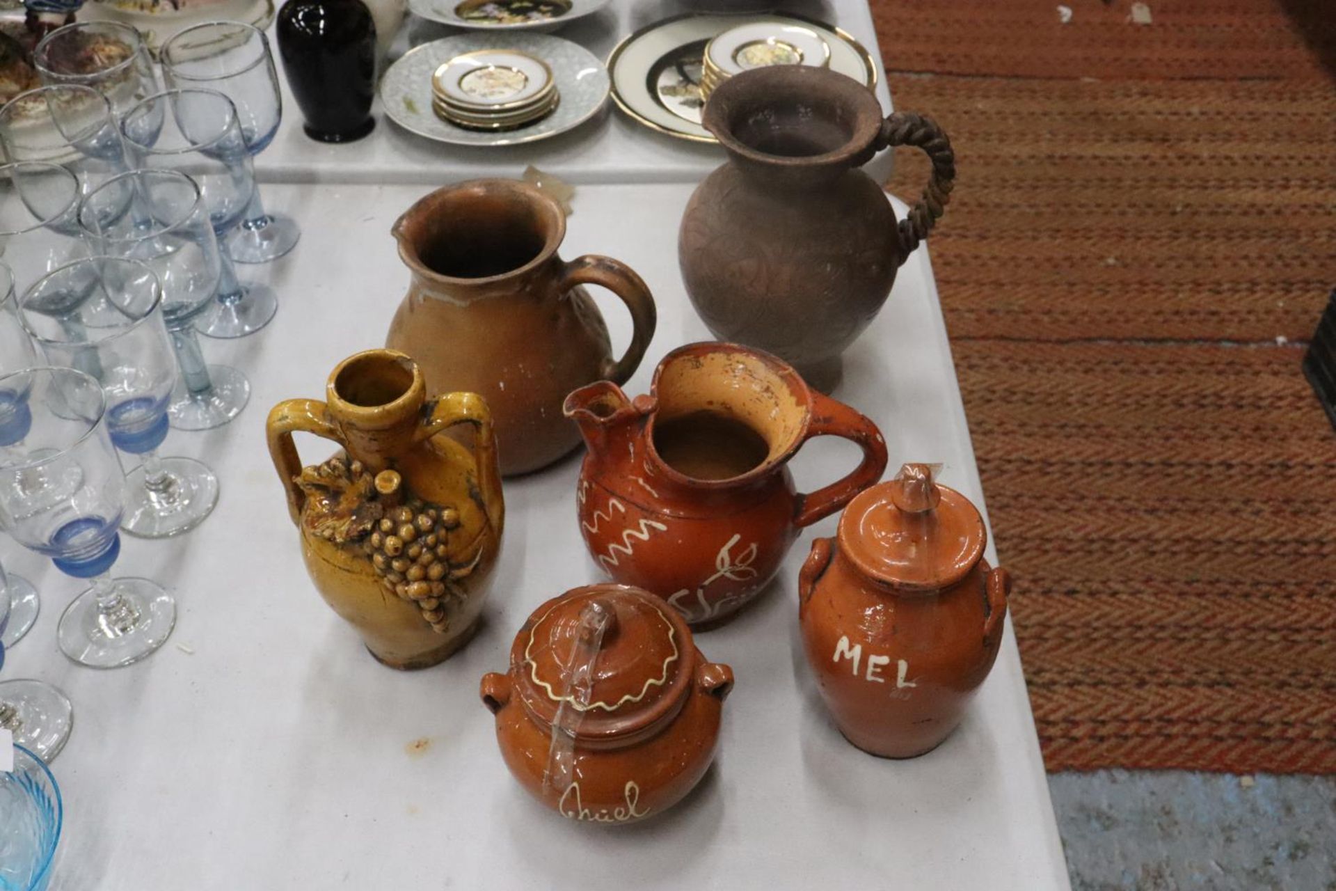 SIX STONEWARE ITEMS TO INCLUDE JUGS, EWER AND LIDDED POTS