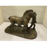 A BRONZE FIGURE OF A MAN WITH A HEAVY HORSE SIGNED R DONALDSON