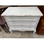 A SHABBY CHIC WHITE CONTINENTAL STYLE CHEST OF THREE DRAWERS - 37 INCH WIDE