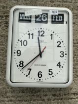 A RETRO AUTOMATIC CALANDER WALL CLOCK