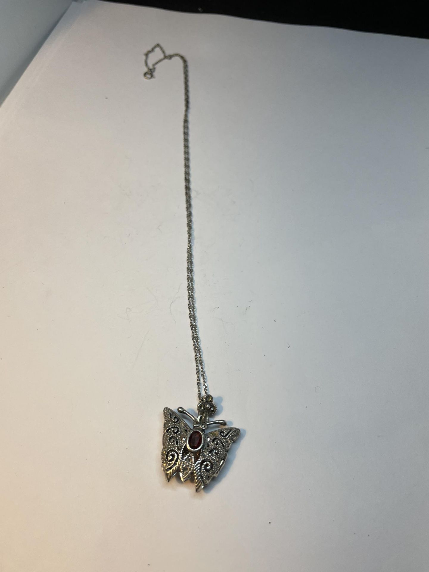 A MARKED 925 SILVER ORNATE BUTTERFLY LOCKET ON A CHAIN