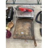 AN ELECTRIC TILE CUTTER AND A VINTAGE GILOTINE