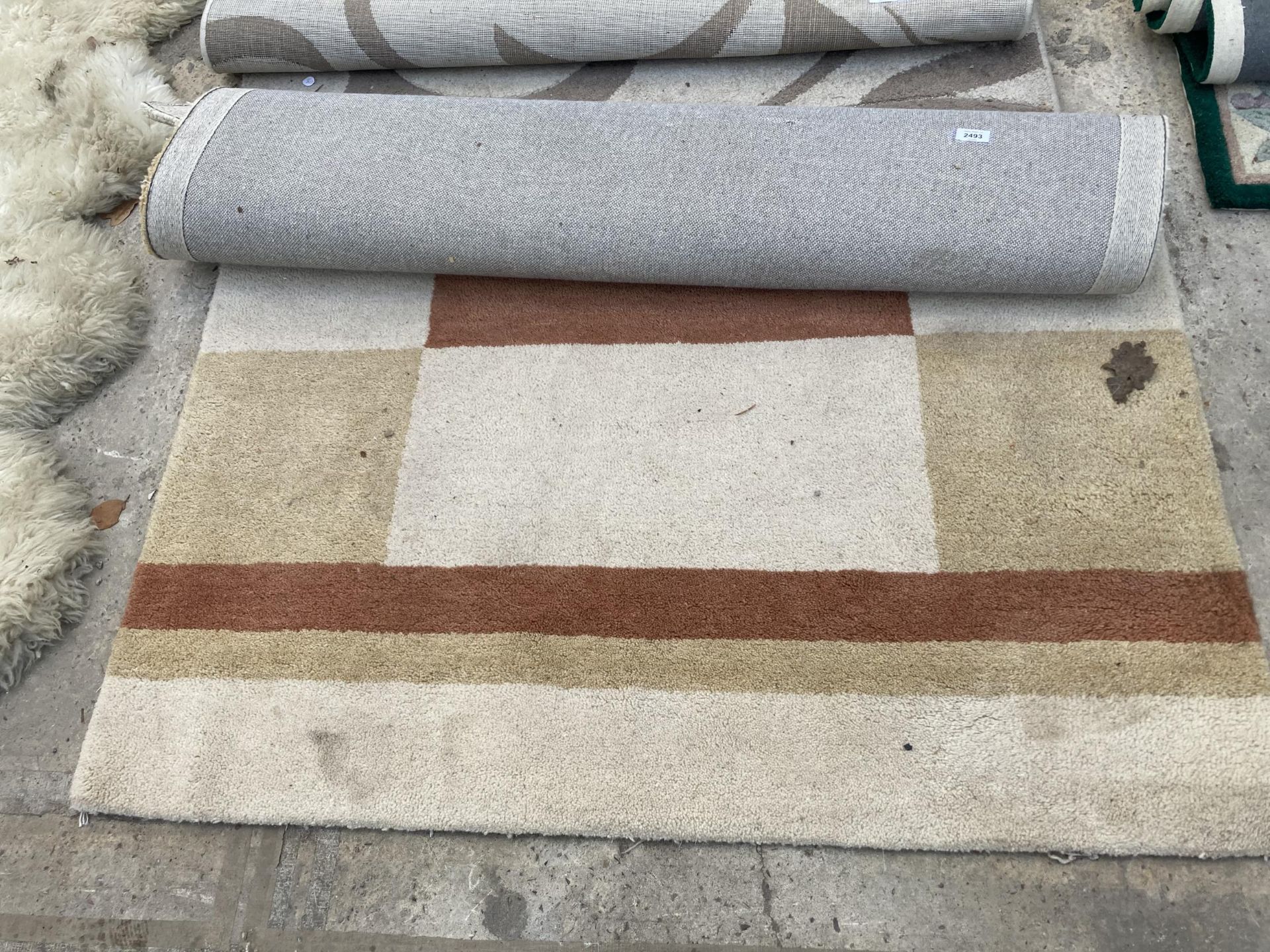 A SMALL CREAM PATTERNED FIRTH RUGS RUG