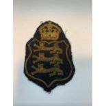 A THREE LIONS BEADED CLOTH BADGE