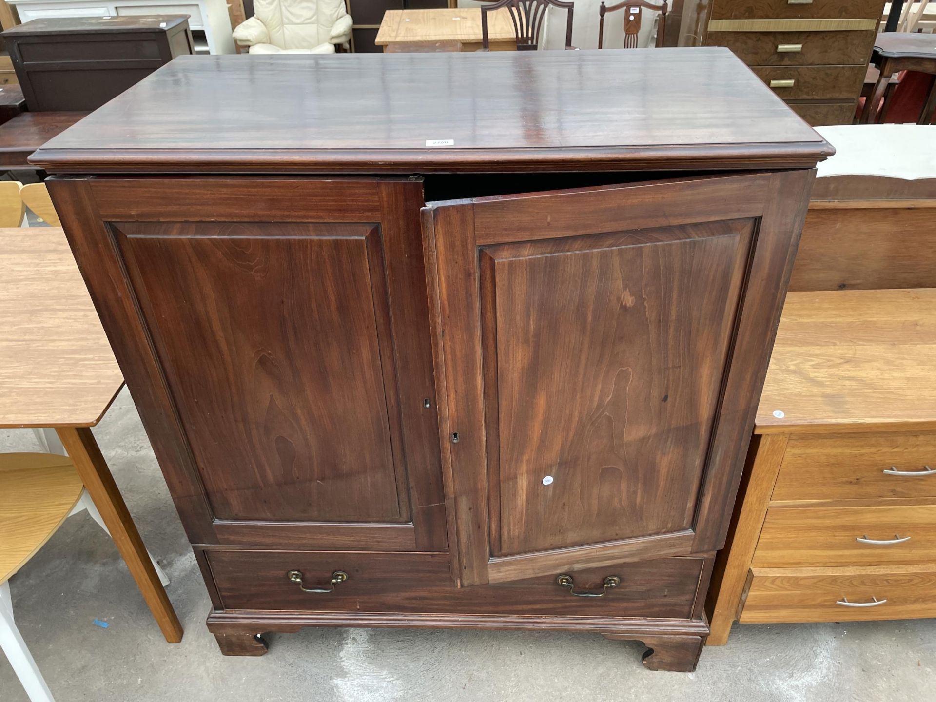 A 19TH CENTURY MAHOGANY PRESS ENCLOSING FIVE SLIDES AND DRAWER TO BASE ON BRACKET FEET 43" WIDE, 22"