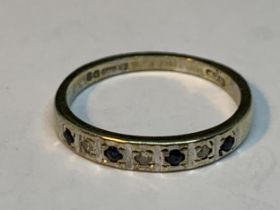 A 9 CARAT GOLD RING WITH FOUR SAPPHIRES AND THREE SAPPHIRES IN LINE SIZE L/M