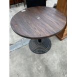A PUB TABLE ON A STEPPED METALWARE BASE 36" DIAMETER