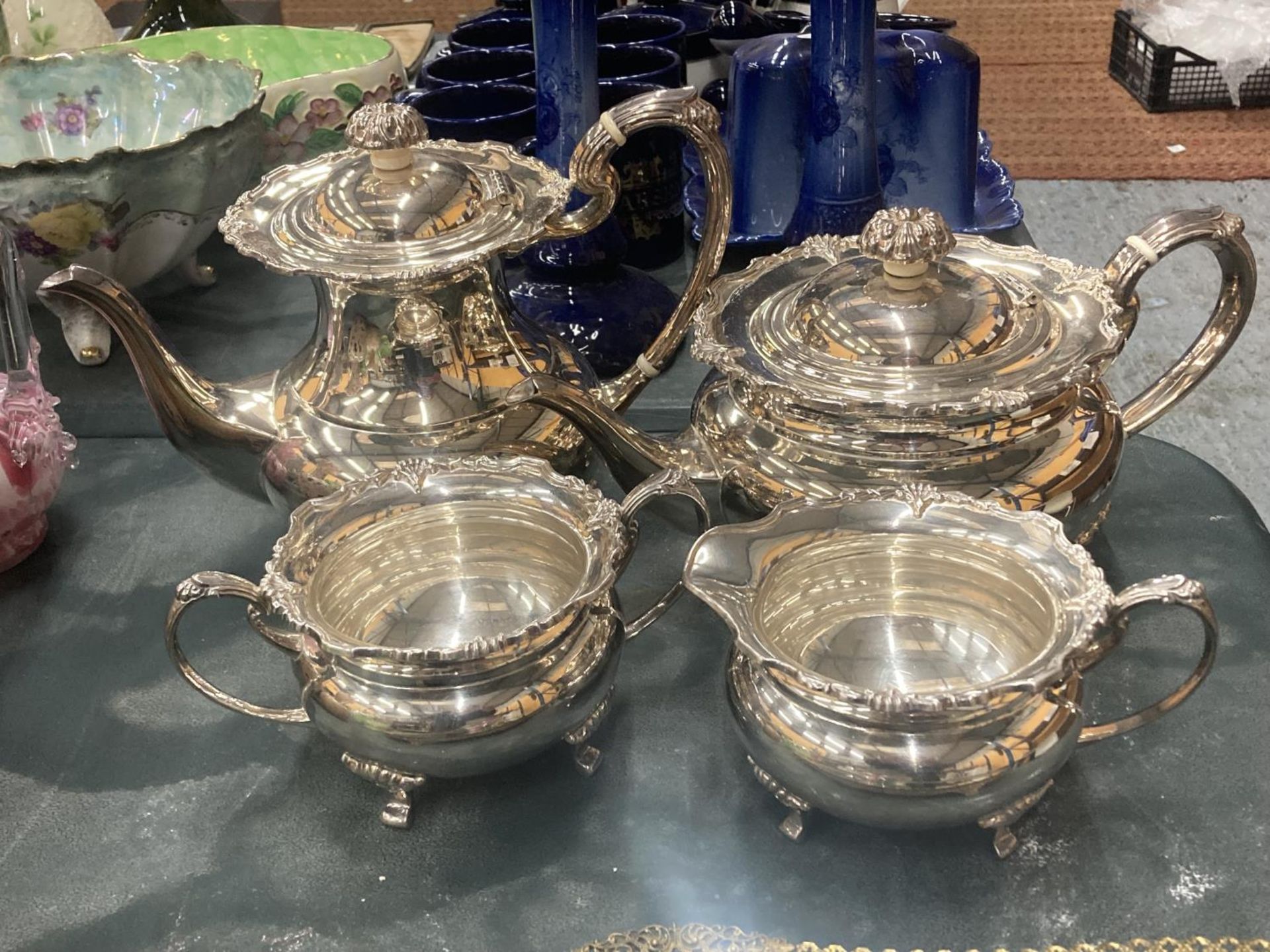A VINTAGE SILVER PLATED TEASET TO INCLUDE A TEAPOT, COFFEE POT, SUGAR BOWL AND CREAM JUG