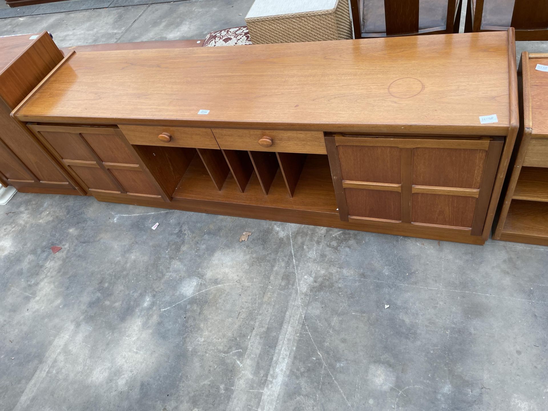 A RETRO TEAK LOW SIDEBOARD ENCLOSING DRAWERS, CUPBOARDS AND RECORD/DOCUMENT RACK - 72 INCH WIDE