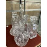 SIX ASSORTED CUT GLASS DECANTERS WITH STOPPERS