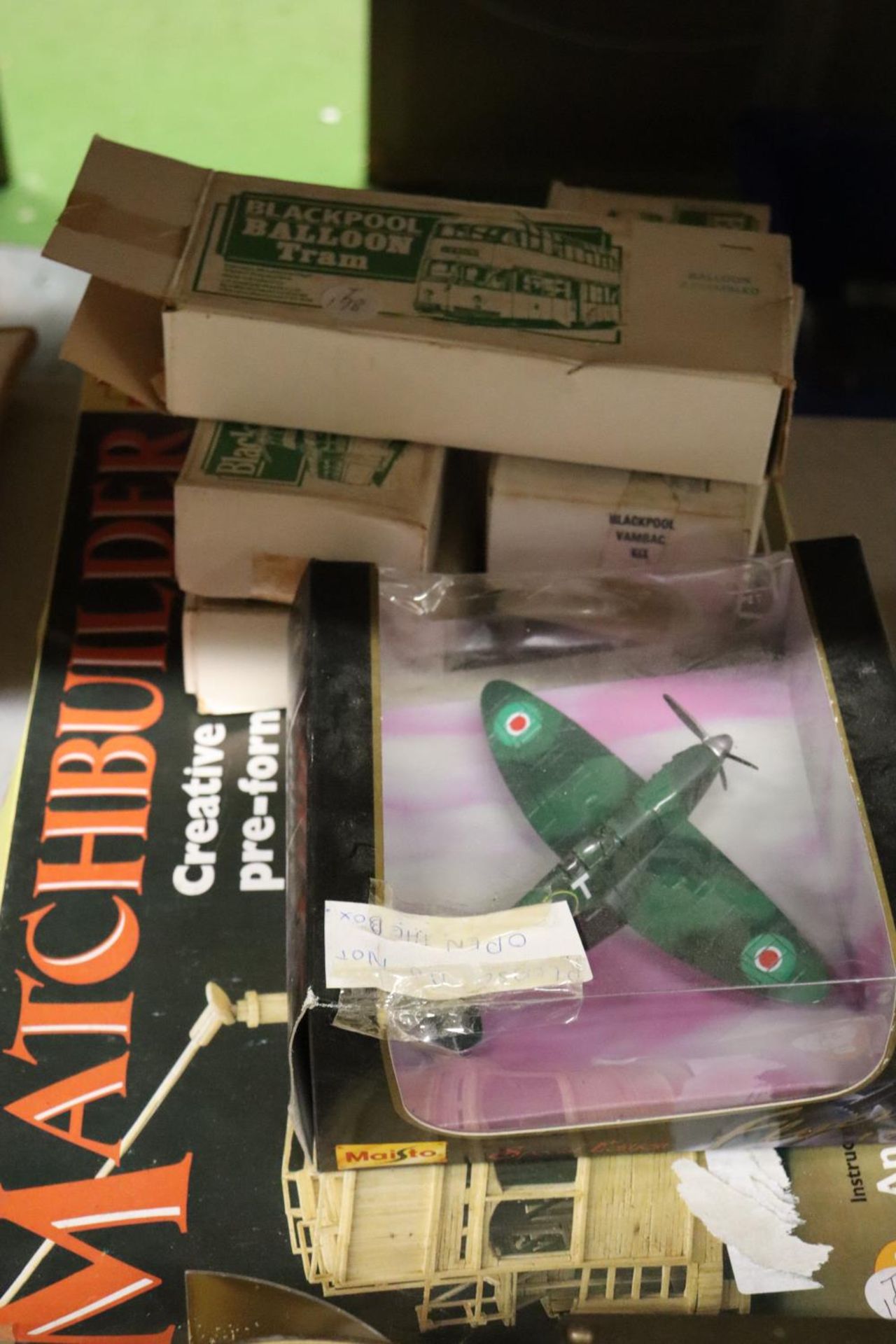 A QUANTITY OF TOYS TO INCLUDE A BOXED SPITFIRE PLANE, TRAMS AND A MATCHBUILDER TRAM KIT