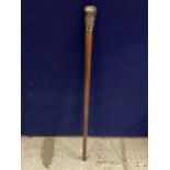 A WALKING STICK WITH A POSSIBLY CONTINENTAL SILVER ORNATE TOP