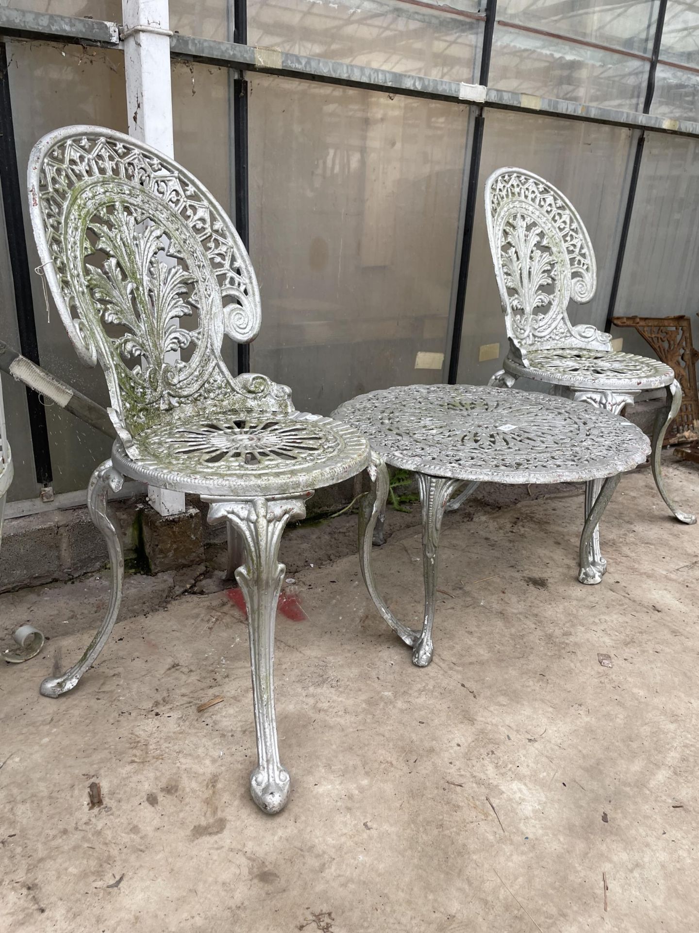 A CAST ALLOY PATIO SET COMPRISING OF TWO CHAIRS AND A ROUND COFFEE TABLE - Image 2 of 4