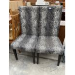 A PAIR OF MODERN HIGH BACK DINING CHAIRS WITH LEOPARD SKIN DESIGN COVERS