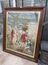 A LARGE WOODEN FRAMED TAPESTRY OF A RELIGIOUS SCENE (142CM x 119CM)