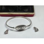 A SILVER MACINTOSH BANGLE AND EARRINGS IN A PRESENTATION BOX