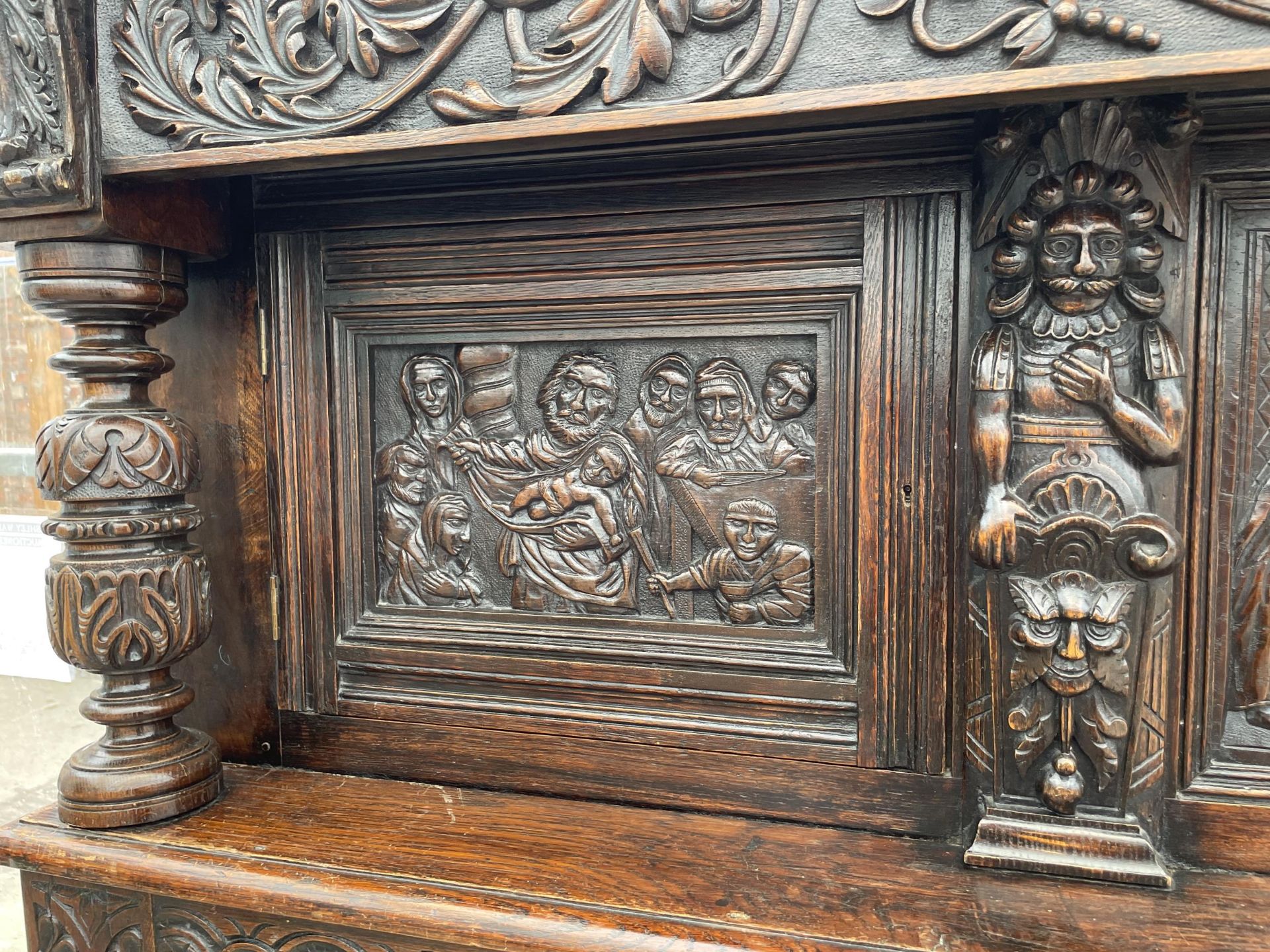 AN OAK GEORGE III STYLE COURT CUPBOARD WITH CARVED PANELS, THREE DEPICTING THE BIRTH AND CRUCIFIXION - Image 8 of 12