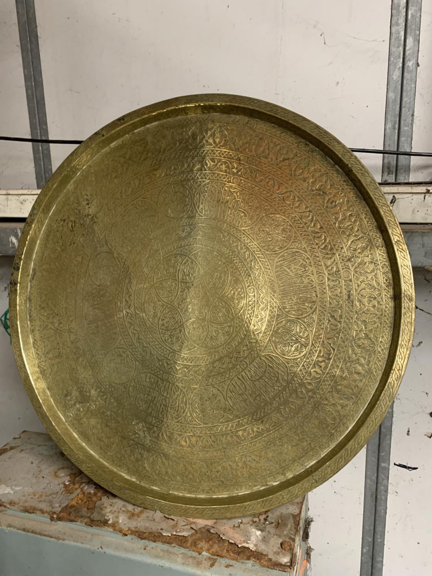 A LARGE HEAVY ISLAMIC BRASS CHARGER, DIAMETER 56CM PLUS A SMALLER PLATE WITH INLAID SILVER AND - Image 3 of 3