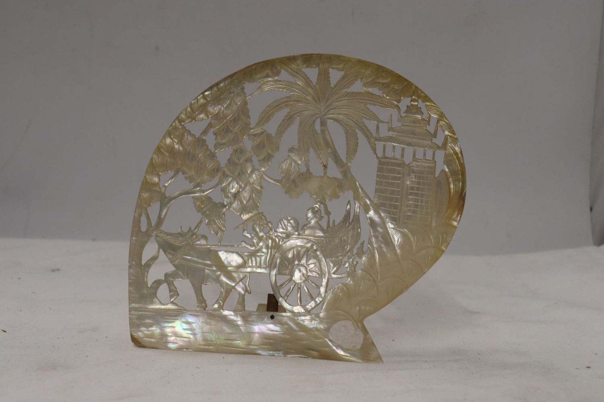 A MOTHER OF PEARL CARVING OF AN ASIAN SCENE, HEIGHT 18CM