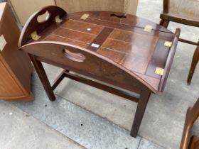 A 19TH CENTURY STYLE COFFEE TABLE IN THE FORM OF A BUTLERS TRAY WITH FOLD DOWN FLAPS