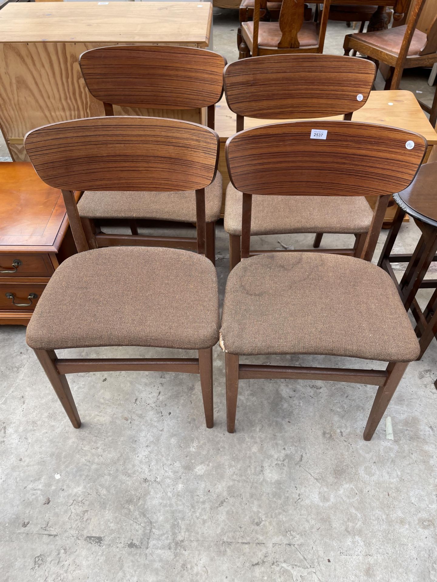 A SET OF FOUR RETRO TEAK DINING CHAIRS