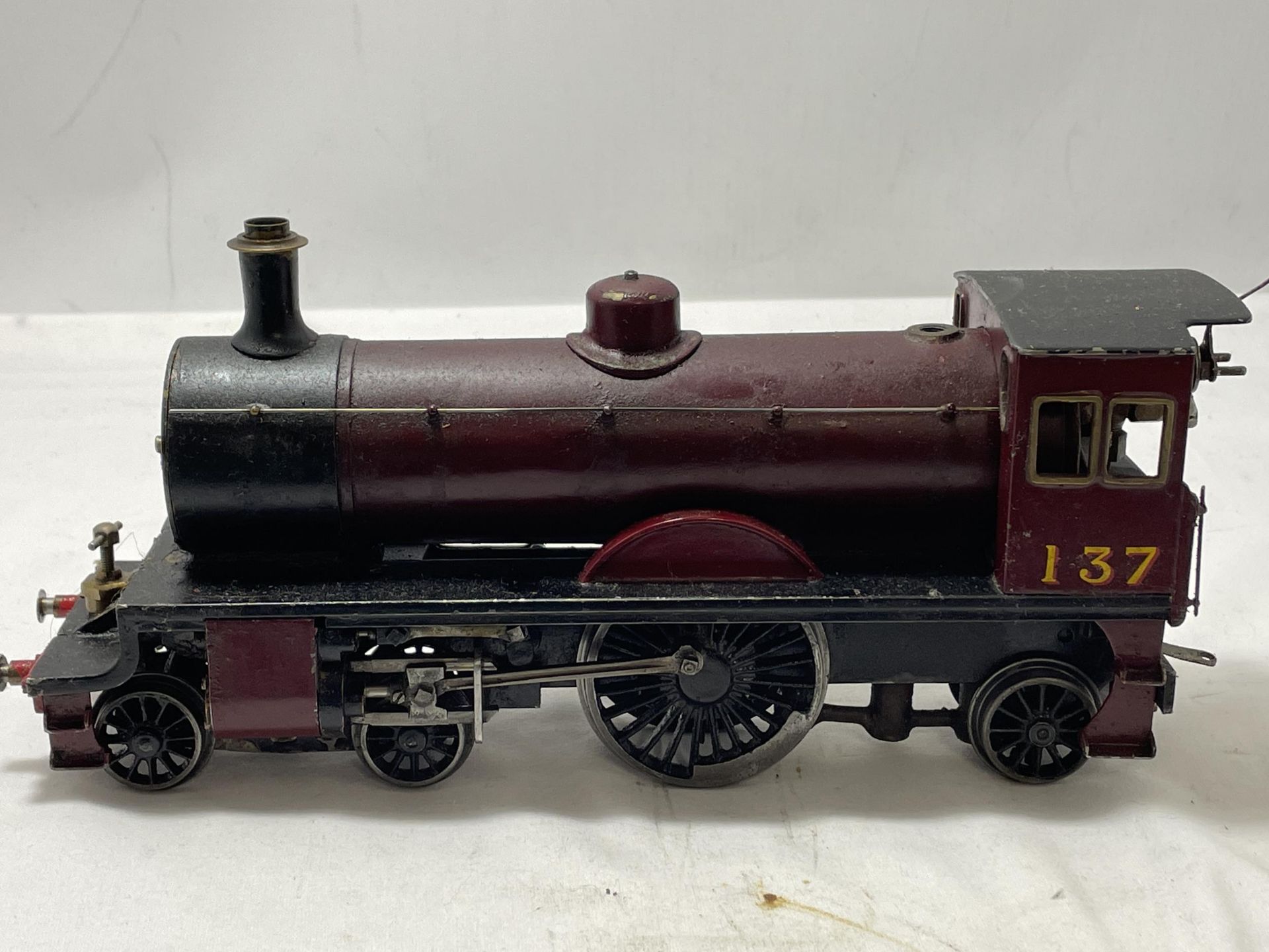 A SCRATCH BUILT LIVE STEAM 30 MM GAUGE 4-2-2 MODEL RAILWAY LOCOMOTIVE NUMBER 137 IN MAROON AND BLACK