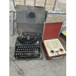A VINTAGE REMINGTON TYPEWRITER WITH CARRY CASE AND A RETRO RADIO