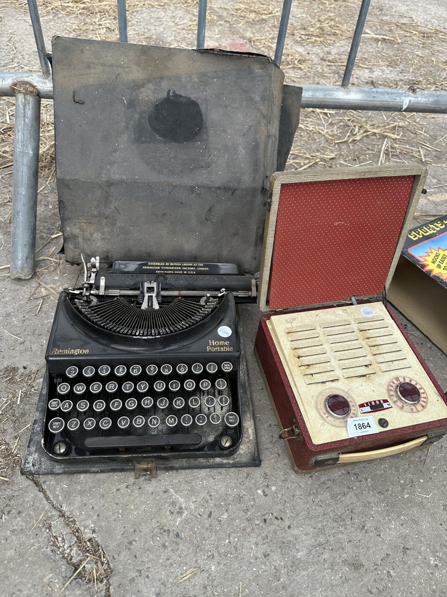 A VINTAGE REMINGTON TYPEWRITER WITH CARRY CASE AND A RETRO RADIO