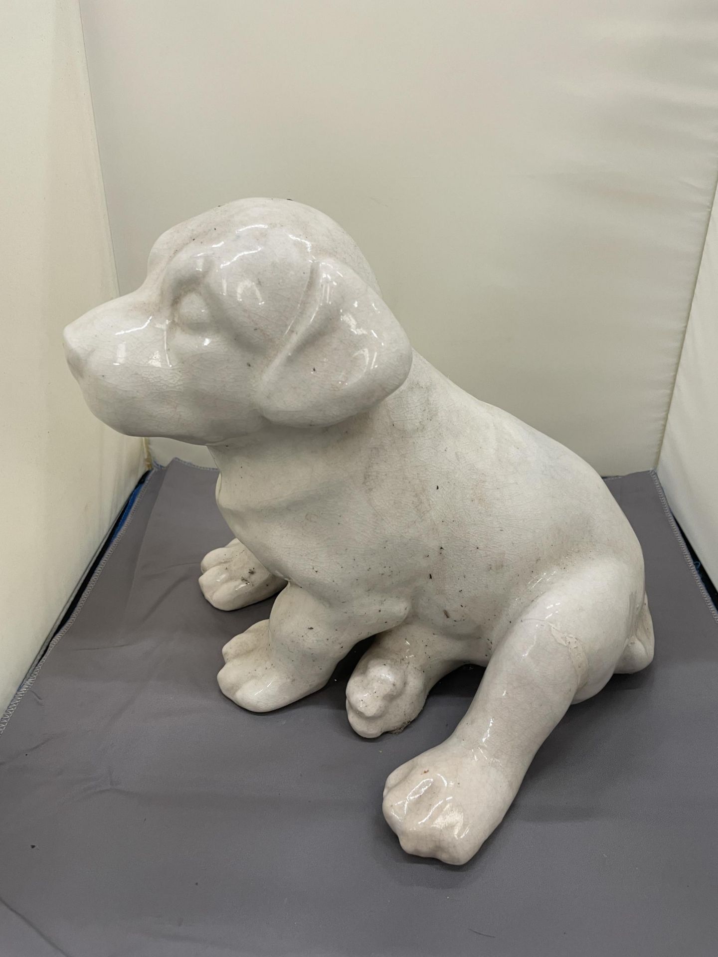 A LARGE CERAMIMC MODEL OF A PUPPY DOG, HEIGHT 26CM, WIDTH 25CM