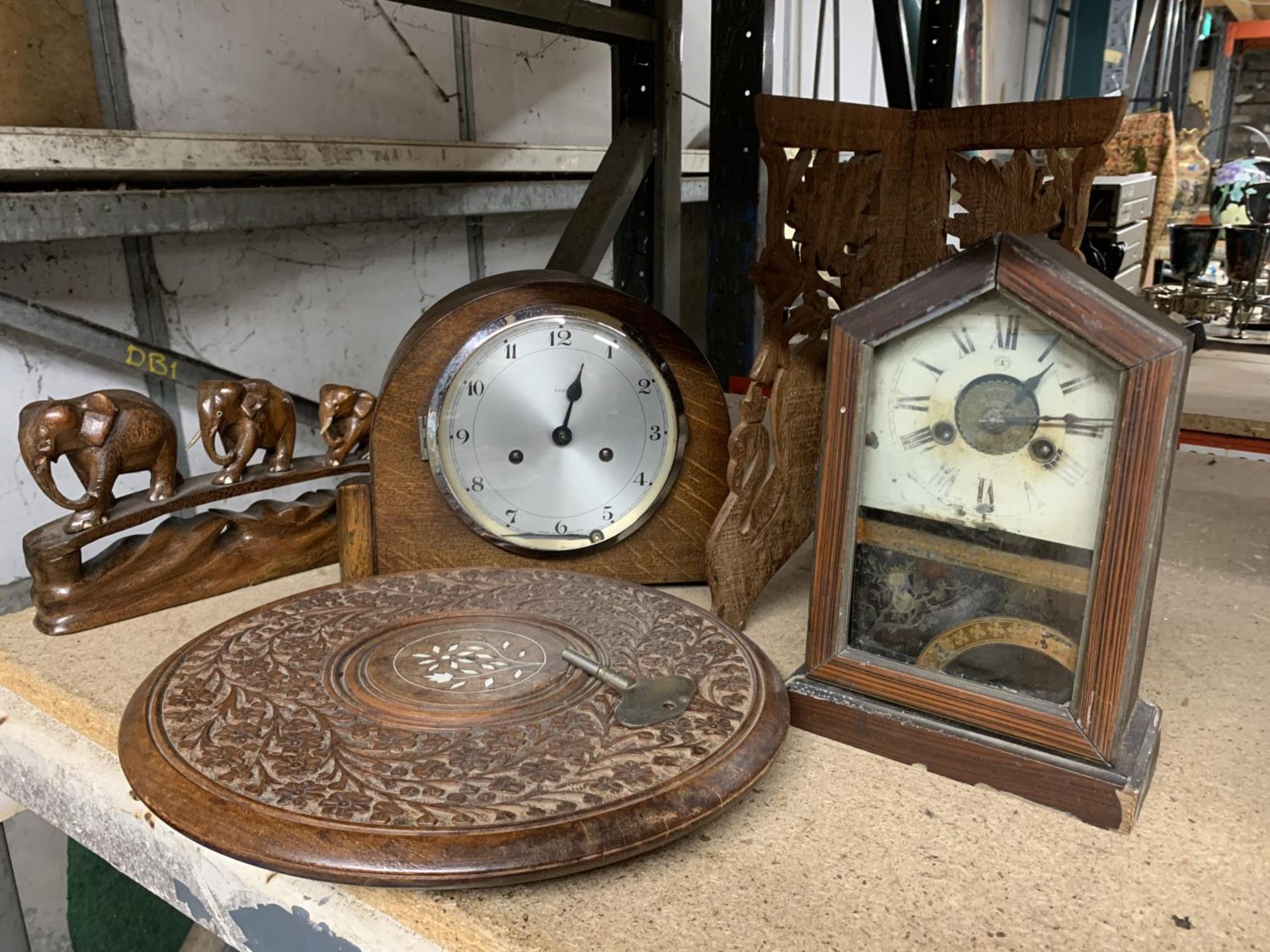 A QUANTITY OF TREEN ITEMS TO INCLUDE TWO MANTLE CLOCKS, ELEPHANTS, BOX AND CARVED TABLE