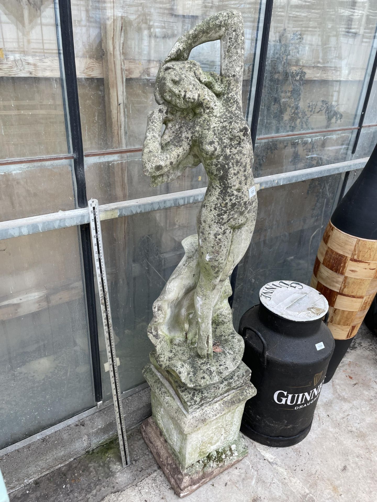 A RECONSTITUTED STONE GARDEN FIGURE OF A NUDE FEMALE ON PEDESTAL BASE (H:148CM)