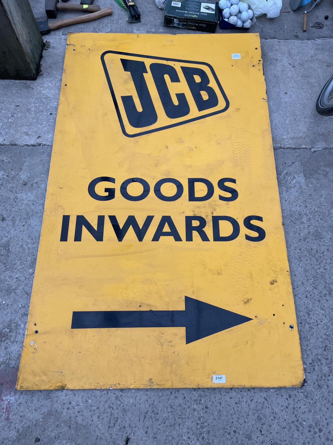 A LARGE METAL JCB GOODS INWARDS SIGN
