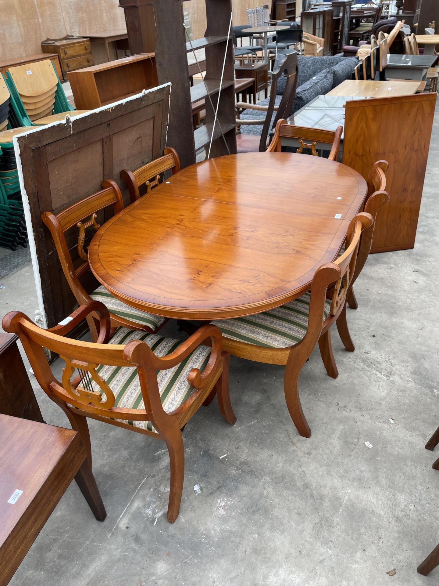 A YEW WOOD EXTENDING DINING TABLE 62" X 39" (LEAF 21.5") AND SIX LYRE BACK DINING CHAIRS ONE BEING A