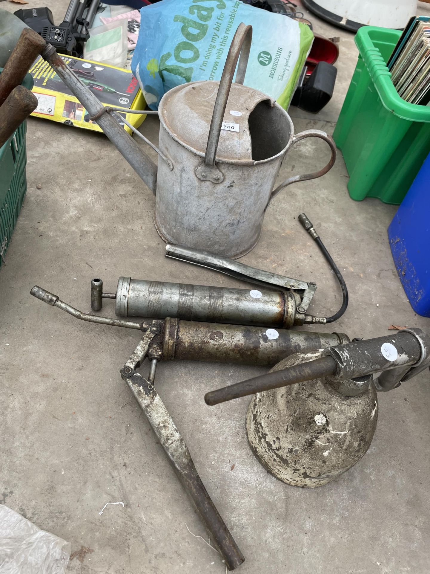 AN ASSORTMENT OF TOOLS TO INCLUDE A GALVANISED WATERING CAN AND TWO GREASE GUNS ETC