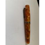 AN ORANGE KRONE FOUNTAIN PEN WITH 18 CARAT GOLD NIB