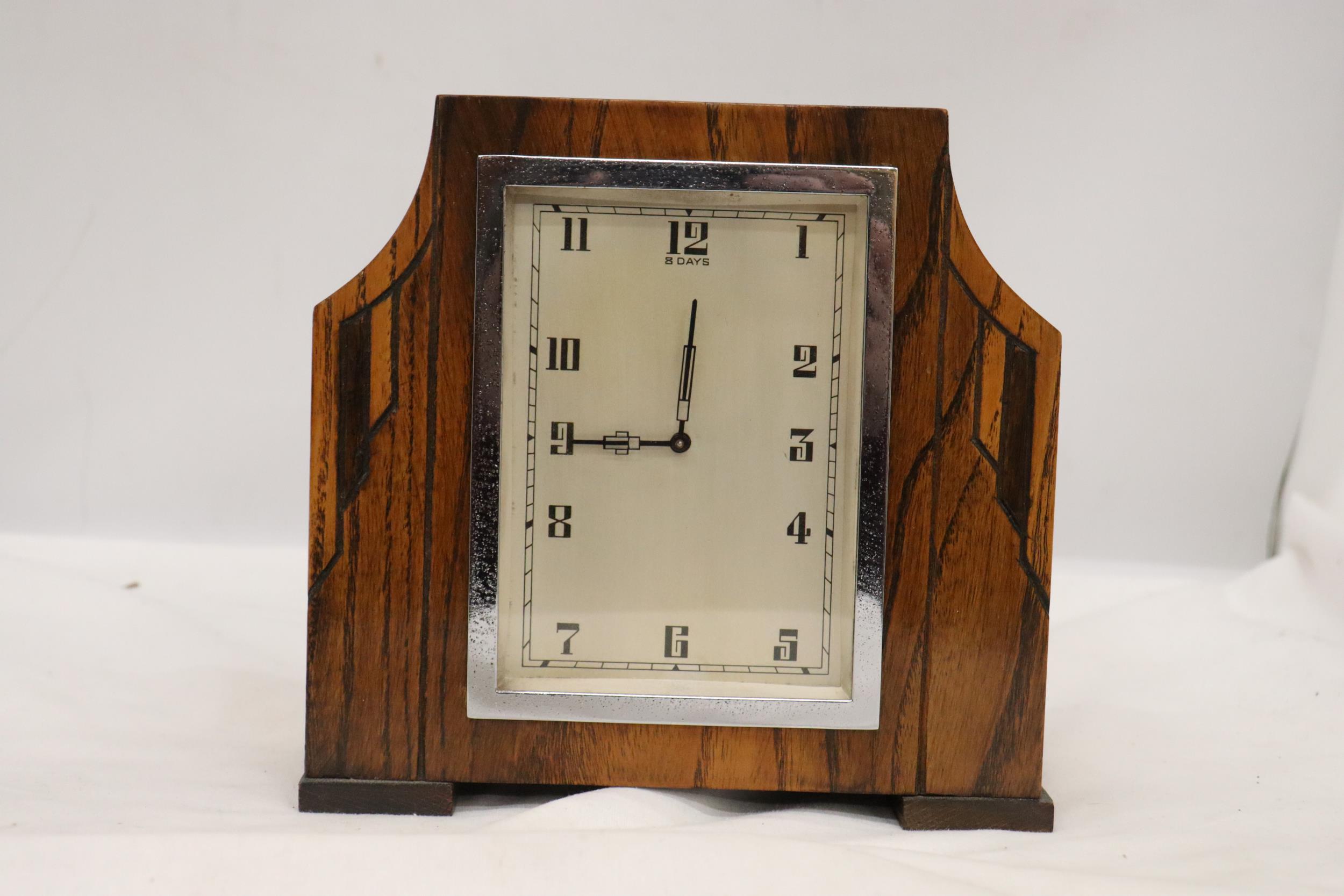 A DECO STYLE OAK 8 DAY MANTLE CLOCK WITH WIND UP MECHANISM SEEN WORKING BUT NO WARRANTY