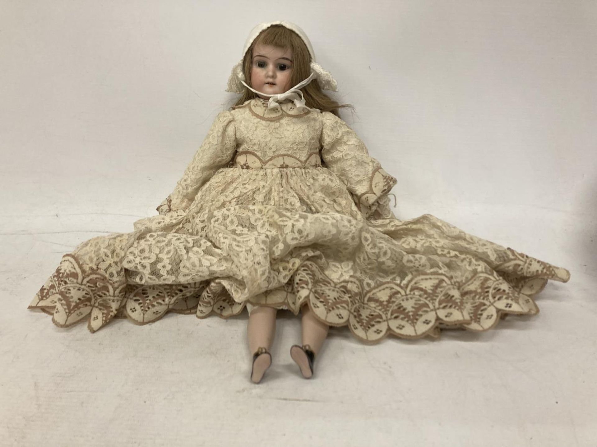 A ARMAND MARSEILLE GERMAN BISQUE DOLL WITH COMPOSITION JOINTED BODY WITH FOUR TEETH WITH VINTAGE