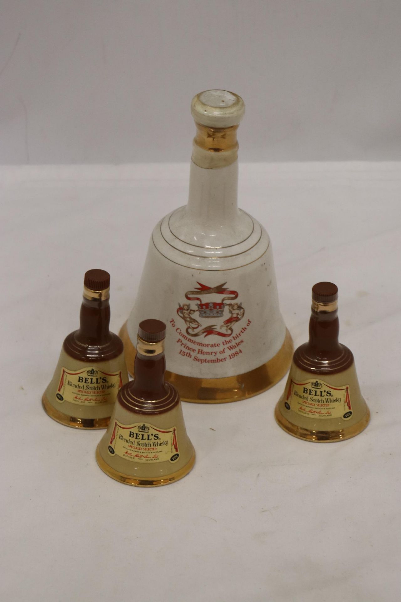 ONE LARGE AND THREE SMALL, BELL'S WHISKY CERAMIC DECANTERS
